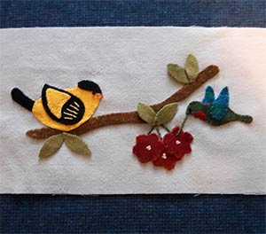 wool embroidery on felt of birds and flowers