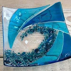 a photo of a glass object with blues and turquoise sections