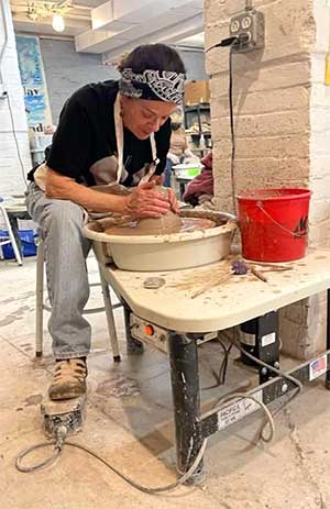 photo of Marybeth Sorendo at the potters wheel