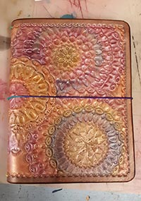 An image showing a mandala stamped travelers notebook