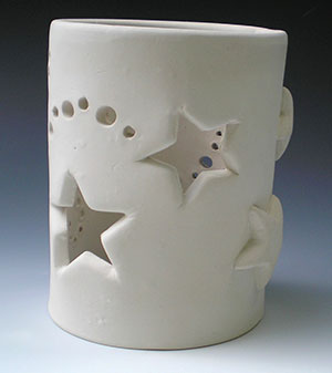 a photo of a piece of pottery that will contain a candle; when lit, the candle light will shine through the stars and circles punched into the pot