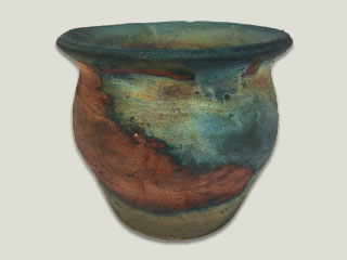 a photo of a raku bowl, an example of raku pottery