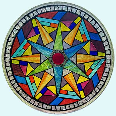 photo of a circular artwork made of many pieces of brightly colored glass