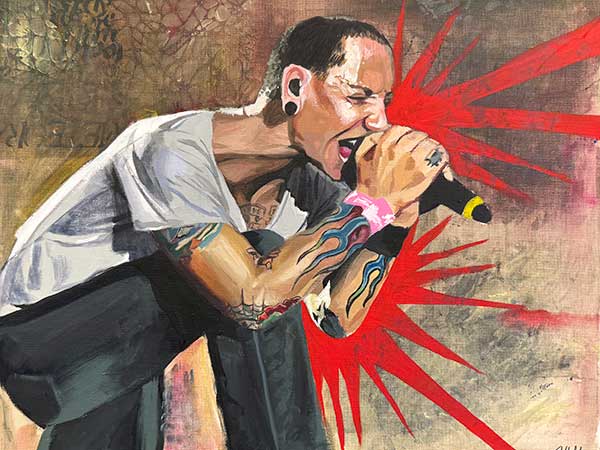 A photo of a student painting showing a male singer singing into a microphone